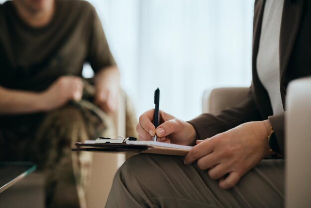therapist writing on clipboard in outpatient treatment